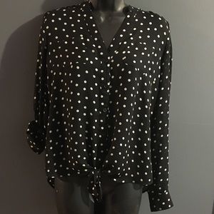 Woman’s black and white Polkadots shirt.